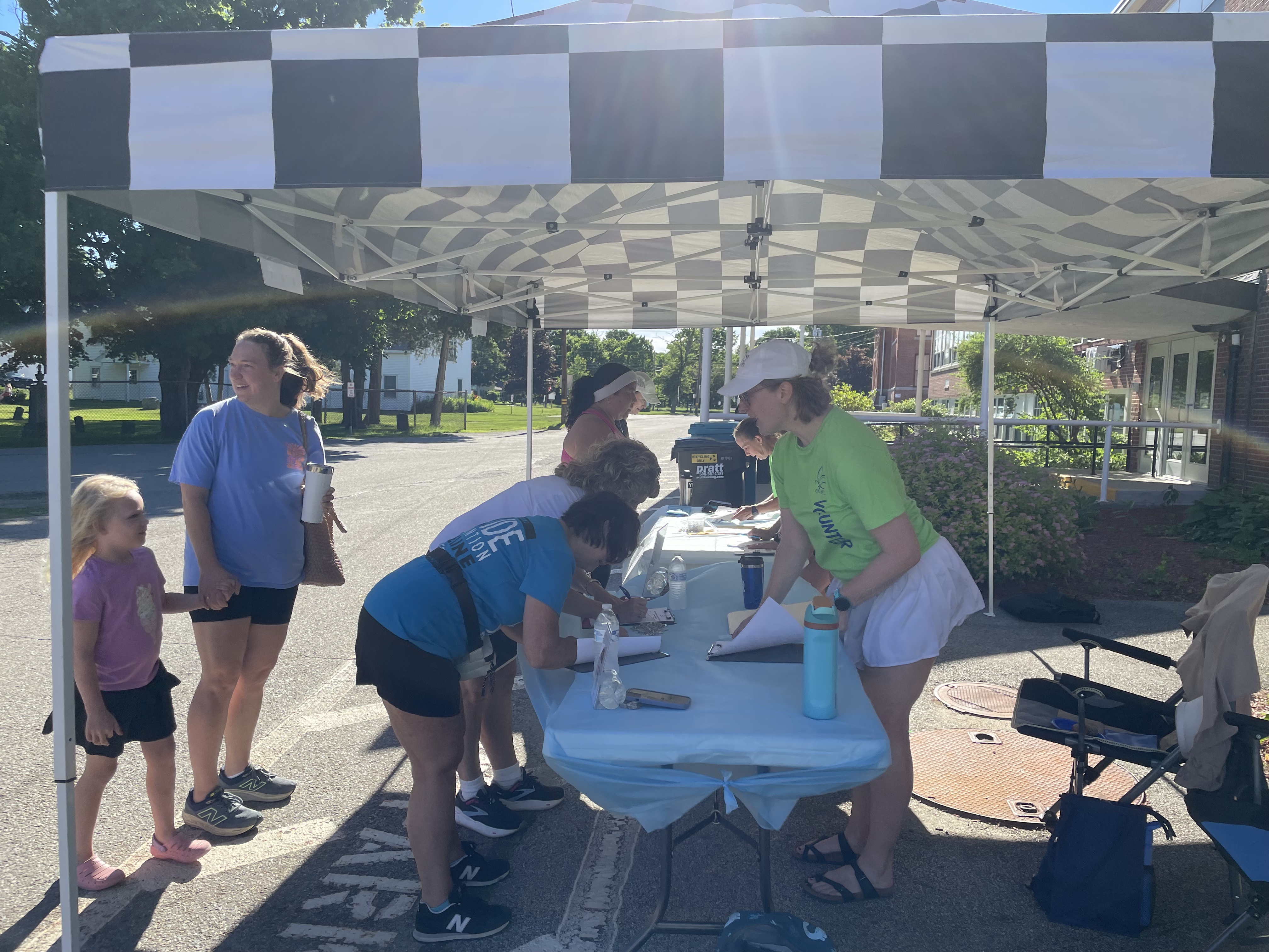 Volunteers checking in runners under the tent